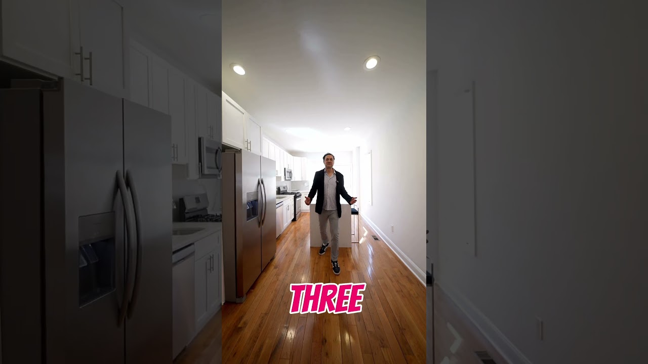 Martin Rodriguez walking through the kitchen of a Point Breeze rowhome during a 19146 listing tour